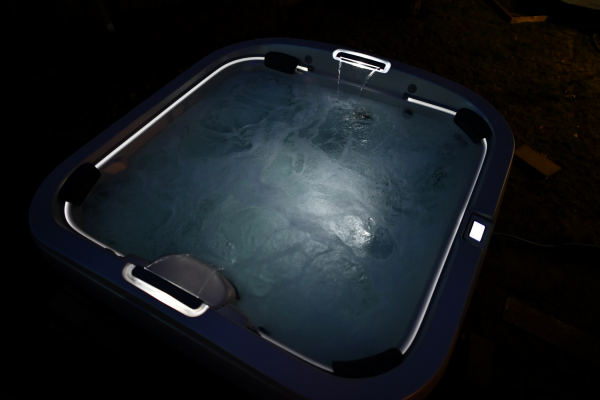 Outdoor hot tub installation illuminated at night